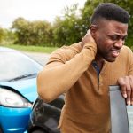 Male,Motorist,With,Whiplash,Injury,In,Car,Crash,Getting,Out