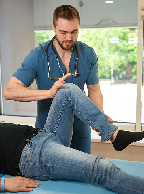 Physiotherapist assessing leg strength