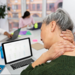 showing a woman with pain from a stiff neck, causing cervicogenic headaches